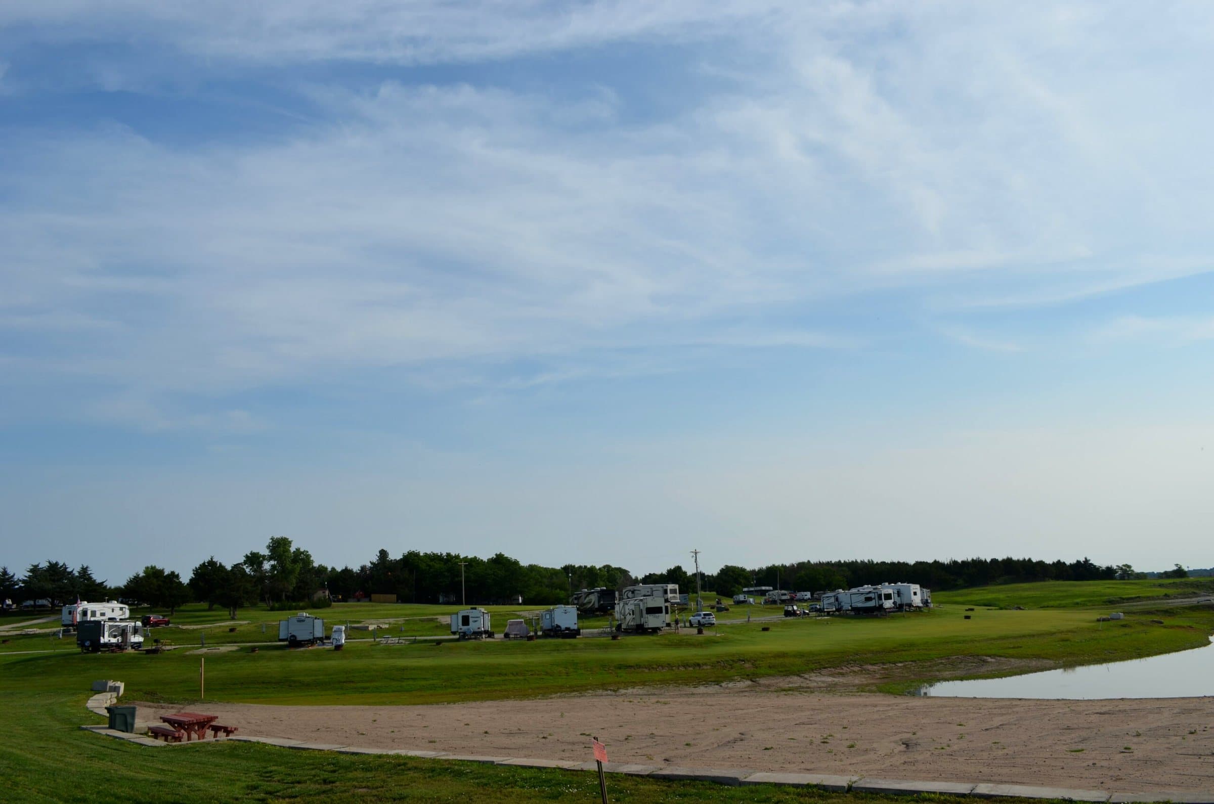 The sandy beach with a picnic table near the water