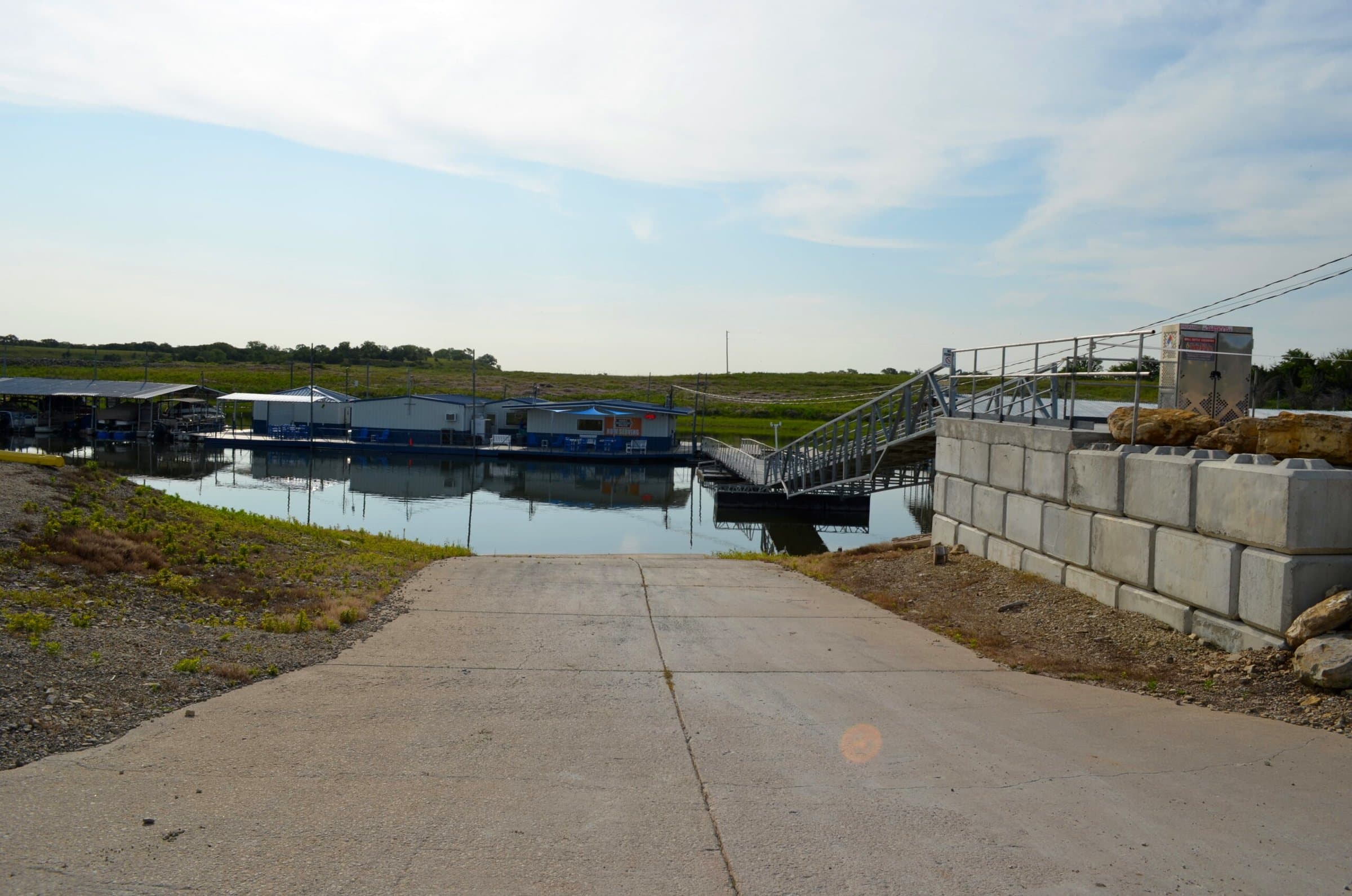 Concrete boat ramp leading down to the marina
