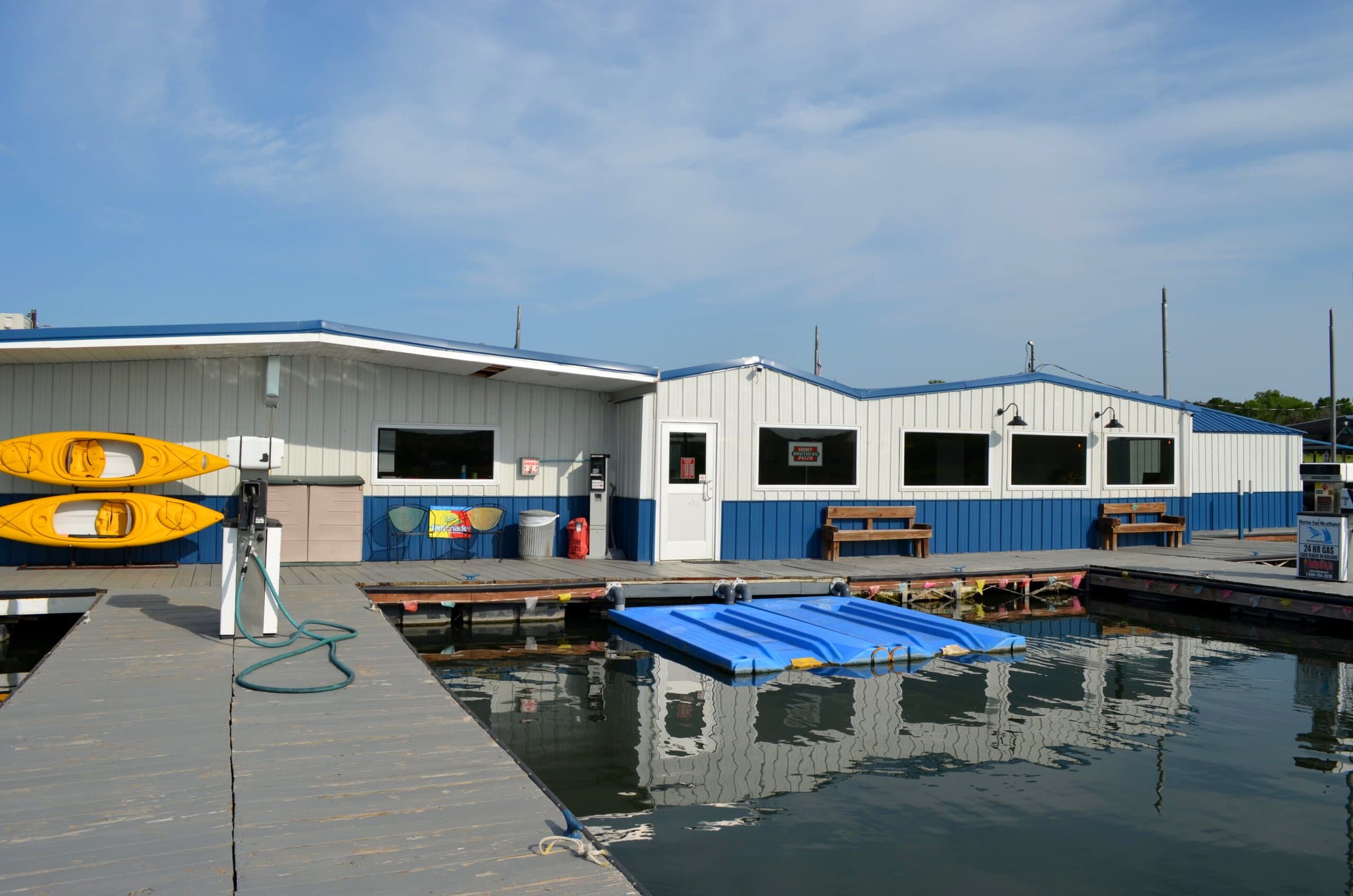 The marina store on the dock, with kayaks on the wall and jet-ski ports alongside